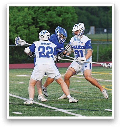 A group of people playing a game of lacrosse on a field. Description generated by AI
