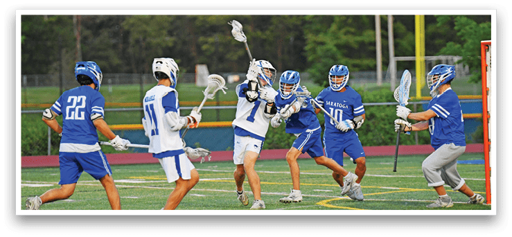 A group of men playing lacrosse on a field. Description generated by AI