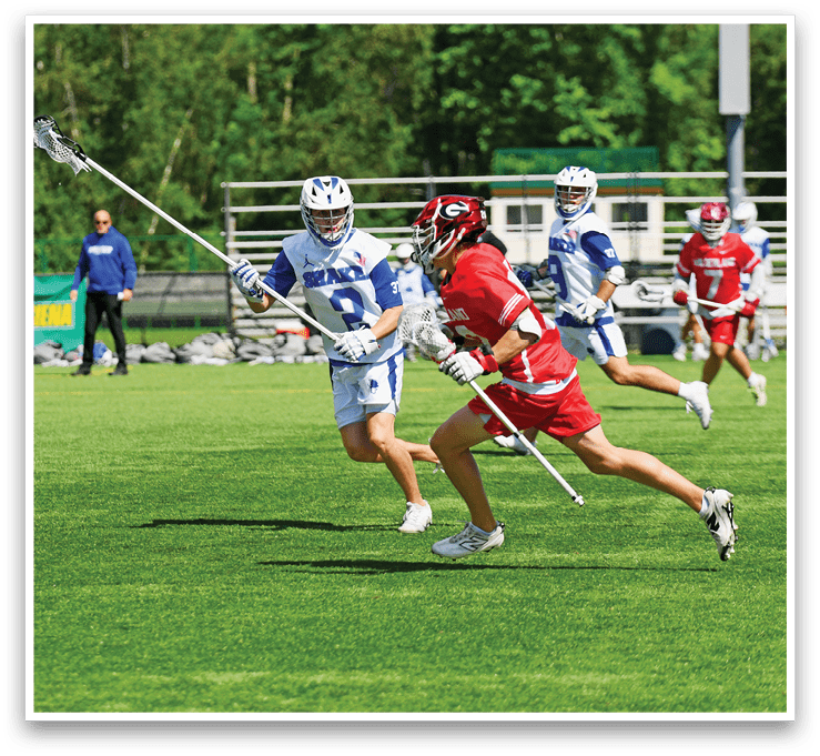 A group of people playing a game of lacrosse. Description generated by AI