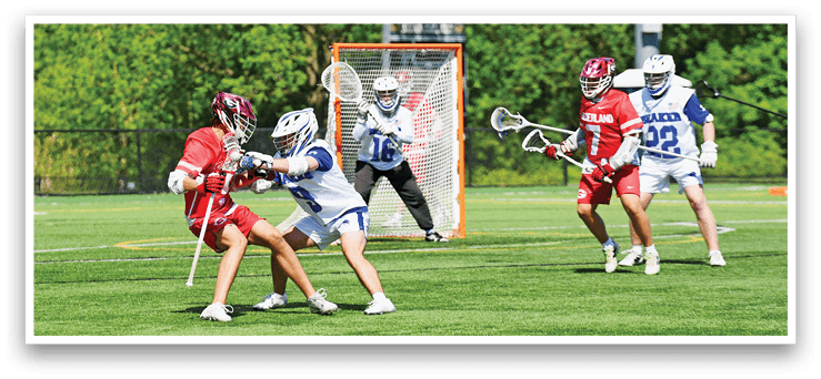 A group of people playing lacrosse on a field. Description generated by AI