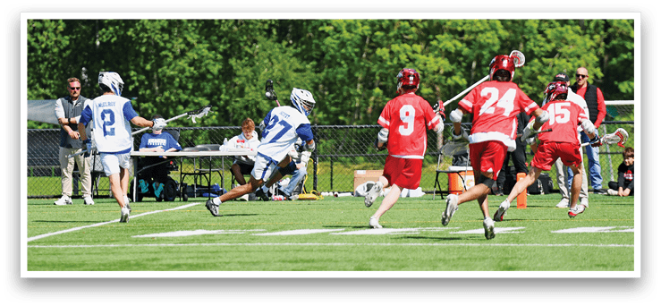 A group of people playing a game of lacrosse. Description generated by AI