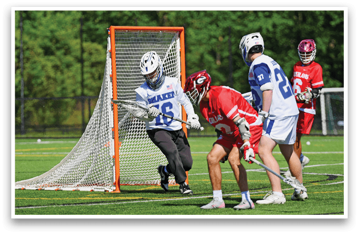 A group of men playing a game of lacrosse. Description generated by AI