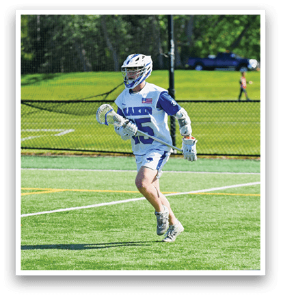 A lacrosse player running on the field. Description generated by AI