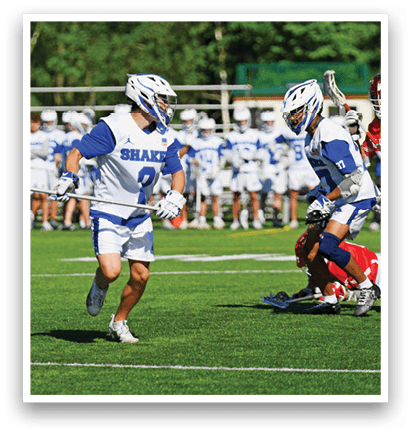 A group of people playing a game of lacrosse. Description generated by AI