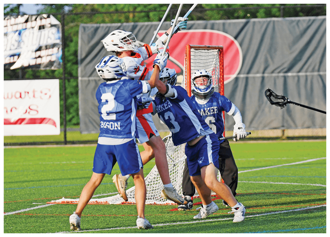 A group of men playing lacrosse on a field. Description generated by AI