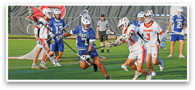 A man in a blue and white uniform is running with a lacrosse stick. Description generated by AI