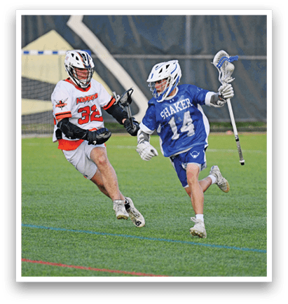Three men playing lacrosse on a field. Description generated by AI
