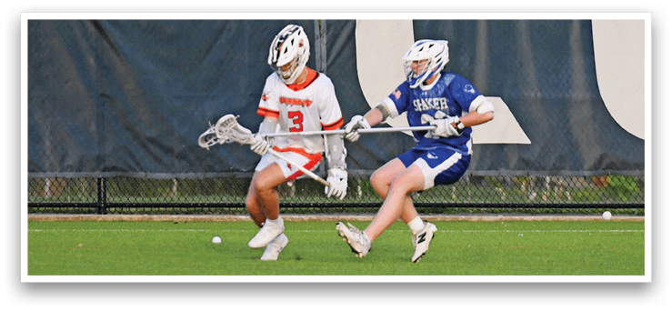 A man in a blue and white uniform is running with a lacrosse stick. Description generated by AI