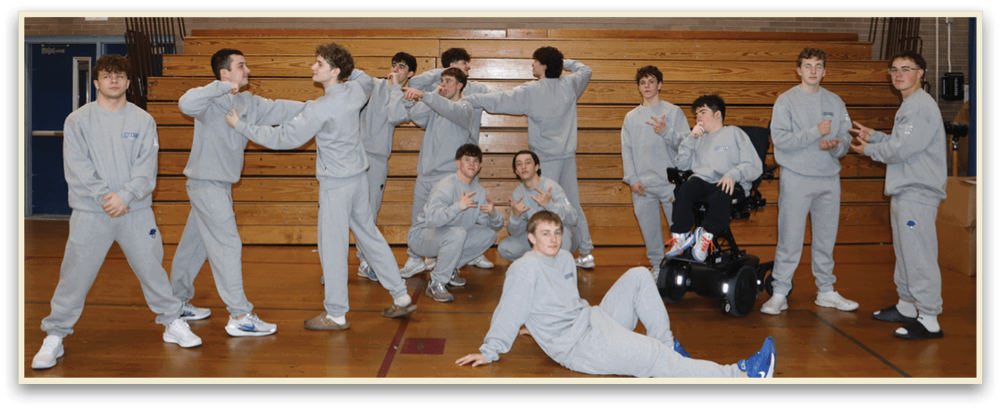 A group of young men in grey sweatshirts pose for a picture in a gym. AI generated content