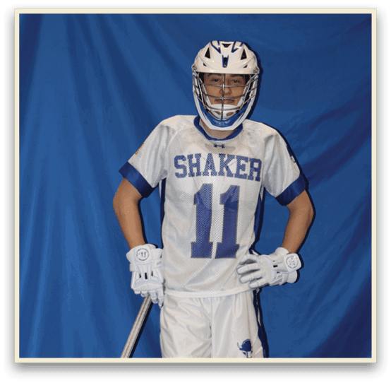 A man wearing a white and blue jersey and holding a lacrosse stick. AI generated content