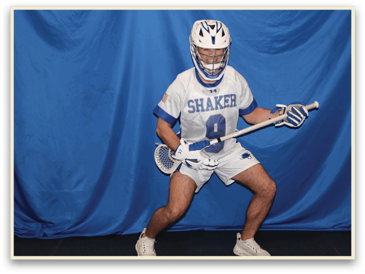 A man wearing a white and blue uniform is holding a lacrosse stick. AI generated content