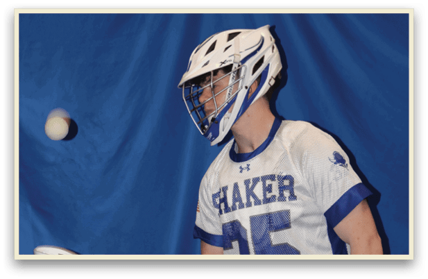 A man wearing a white and blue jersey holds a lacrosse stick. AI generated content
