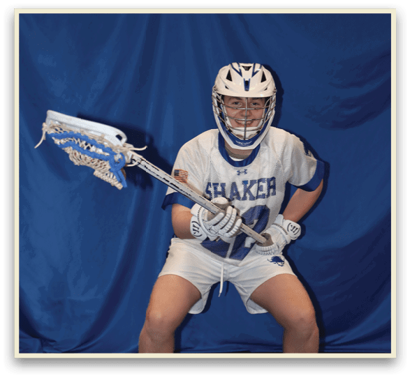 A man is sitting on the ground holding a lacrosse stick. AI generated content