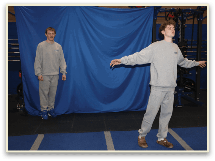 Two men standing in a gym, one with his arms outstretched and the other with his arms at his sides. AI generated content