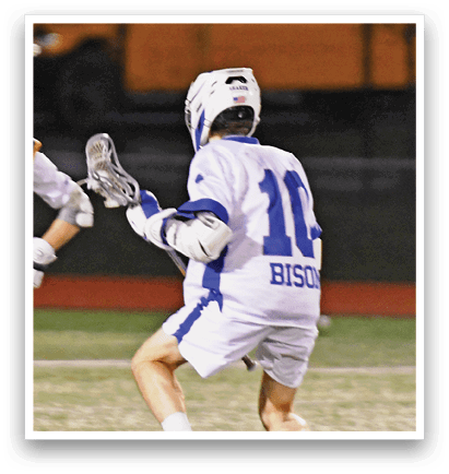 Two men playing lacrosse on a field. One man is wearing a blue jersey and the other is wearing a white jersey. AI generated content