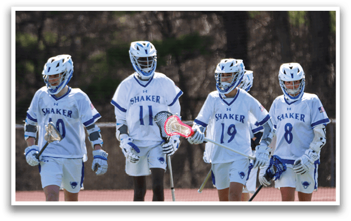 Four lacrosse players wearing blue and white uniforms are walking on a field. AI generated content