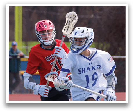 Two lacrosse players running on a field, one wearing a red shirt and the other wearing a white shirt. AI generated content
