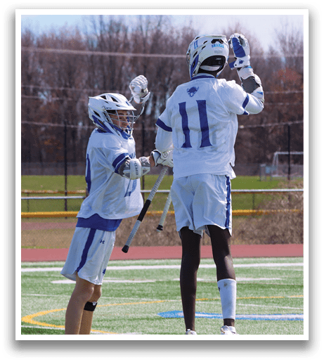 Two young men are playing a game of lacrosse on a field. One of the players is jumping in the air, holding a lacrosse stick, while the other player is holding a stick and watching the action. AI generated content