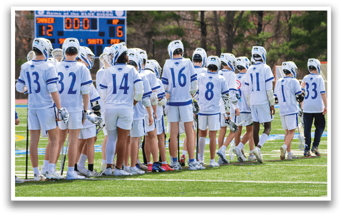 A group of lacrosse players are standing on a field, wearing their uniforms and holding their sticks. AI generated content