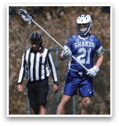 A man wearing a blue and white jersey holds a lacrosse stick while standing next to a referee. AI generated content