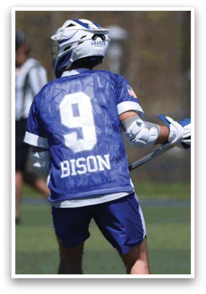 A man wearing a blue and white jersey with the number 9 on it is holding a lacrosse stick. AI generated content