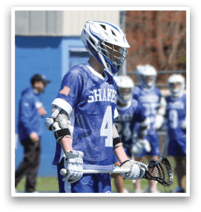 A man wearing a blue and white jersey with the number 4 on it is holding a lacrosse stick. AI generated content