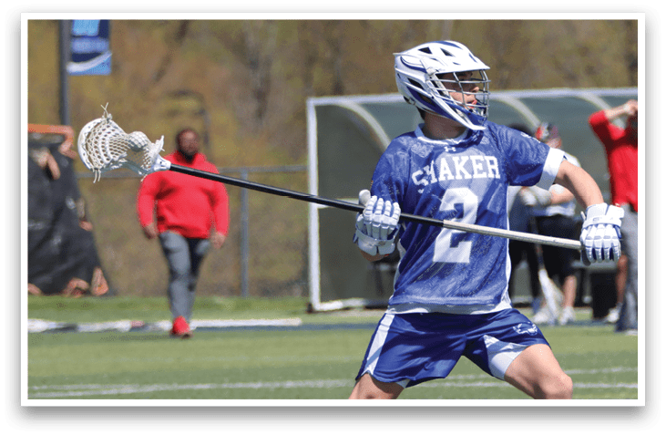 A lacrosse player in a blue and white uniform is holding a stick and preparing to shoot the ball. AI generated content