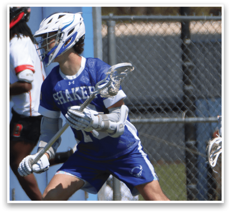 A man in a blue and white uniform is holding a lacrosse stick and running on a field. AI generated content