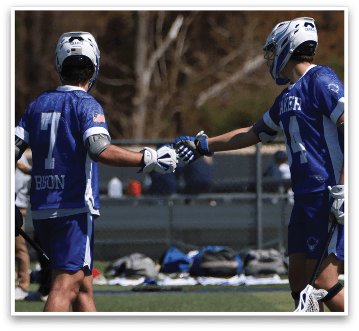 Two men shake hands on a field, both wearing blue and white uniforms. AI generated content