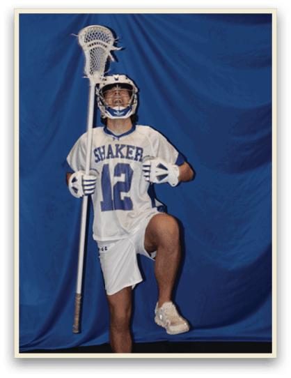 A man wearing a white jersey with the number 12 holds a lacrosse stick. AI generated content