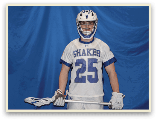 A man wearing a Shaker jersey and helmet is holding a lacrosse stick. AI generated content