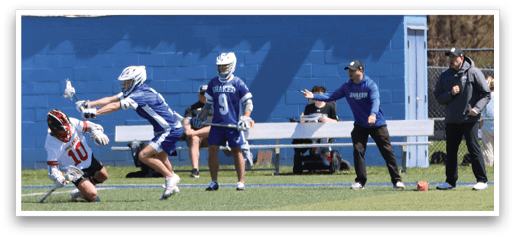 A group of people are playing a game of lacrosse. One player is falling to the ground while another player is holding a lacrosse stick. AI generated content