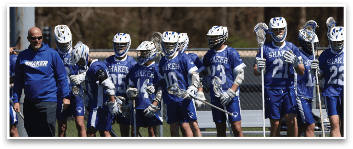A group of lacrosse players wearing blue uniforms and helmets are lined up on a field. AI generated content