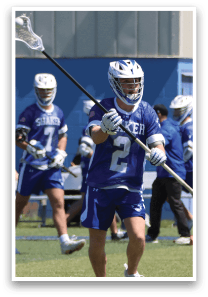 A lacrosse player in a blue uniform is holding a stick and running on the field. AI generated content