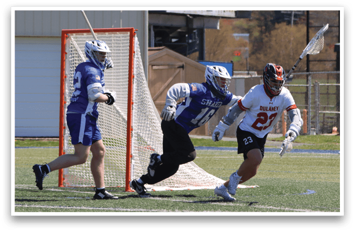 Three men playing lacrosse on a field. One man is running with a stick, while another man is trying to block him. AI generated content