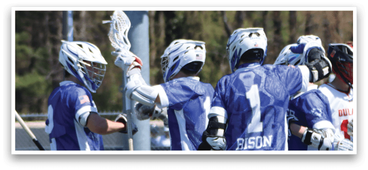 A group of men wearing blue and white uniforms are standing on a field. They are holding their lacrosse sticks and appear to be celebrating a victory. AI generated content