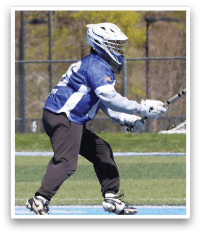 A man wearing a blue and white jersey is playing lacrosse. He is holding a lacrosse stick and preparing to shoot the ball. AI generated content