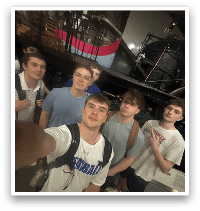 A group of young men pose for a picture in front of a train. AI generated content