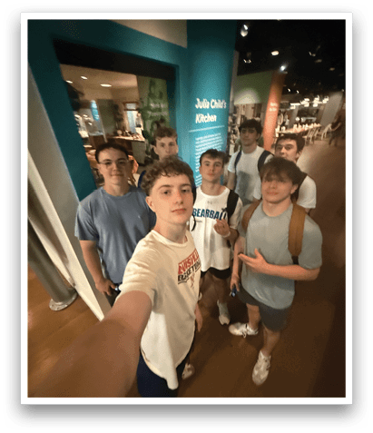 A group of young men pose for a picture in a museum. AI generated content