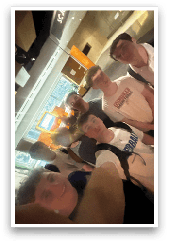 A group of young men are standing together in a room, posing for a picture. AI generated content