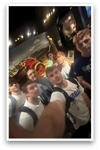 A group of young men pose for a picture in front of a fire engine. AI generated content