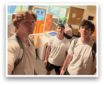 Three young men pose for a picture in front of a TV. AI generated content