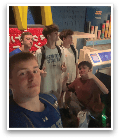 Four young men are standing in front of a Mcdonald's restaurant. AI generated content