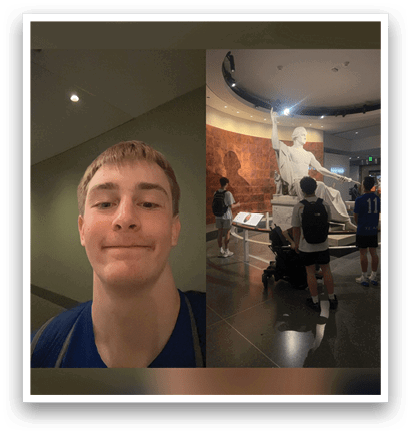 A young man with a blue shirt is standing in front of a statue. AI generated content