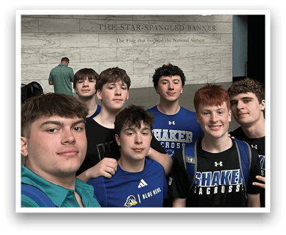 A group of young men pose for a picture in front of a large sculpture. AI generated content