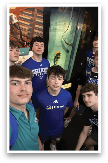A group of young men pose for a picture in front of a display case. AI generated content