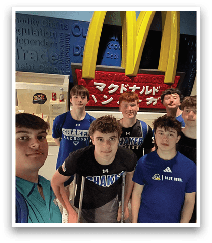 A group of young men pose for a picture in front of a Mcdonald's sign. AI generated content