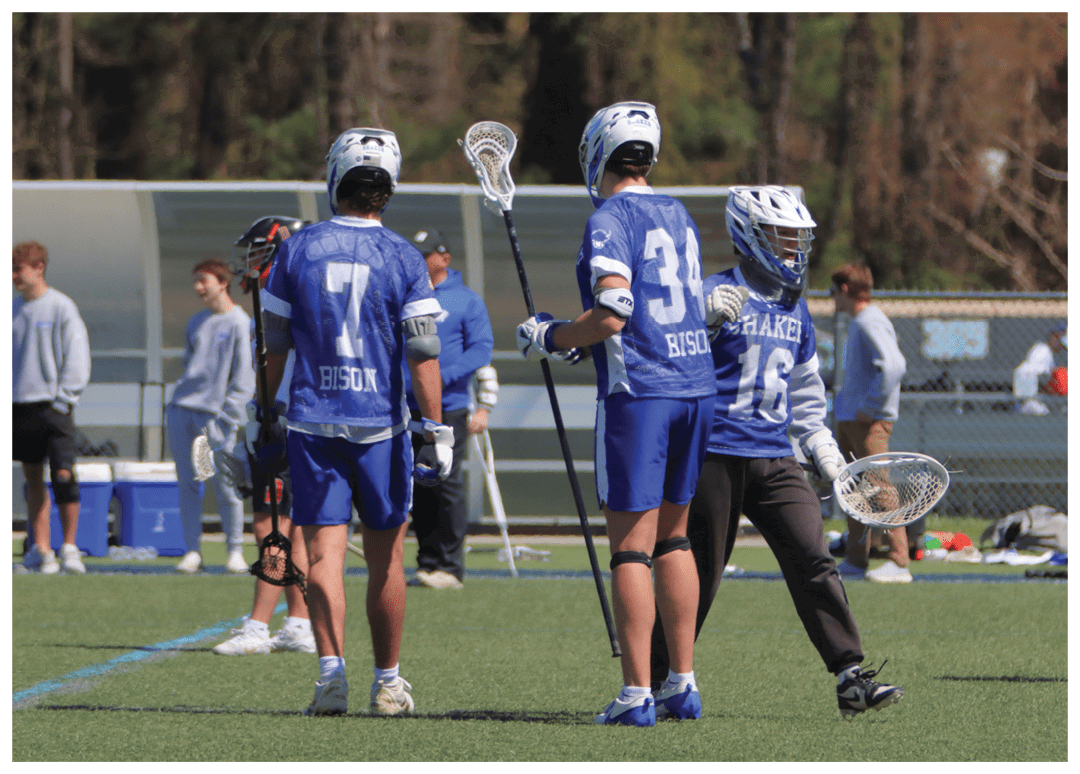 A group of people are playing a game of lacrosse on a field. AI generated content