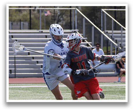 Two lacrosse players are running on a field, one with a blue uniform and the other with a red uniform. AI generated content