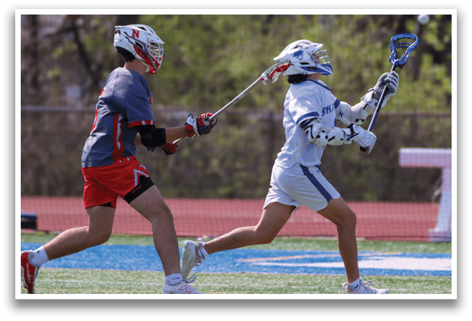 Two men playing lacrosse on a field. One man is running with a stick, while the other is trying to block him. AI generated content